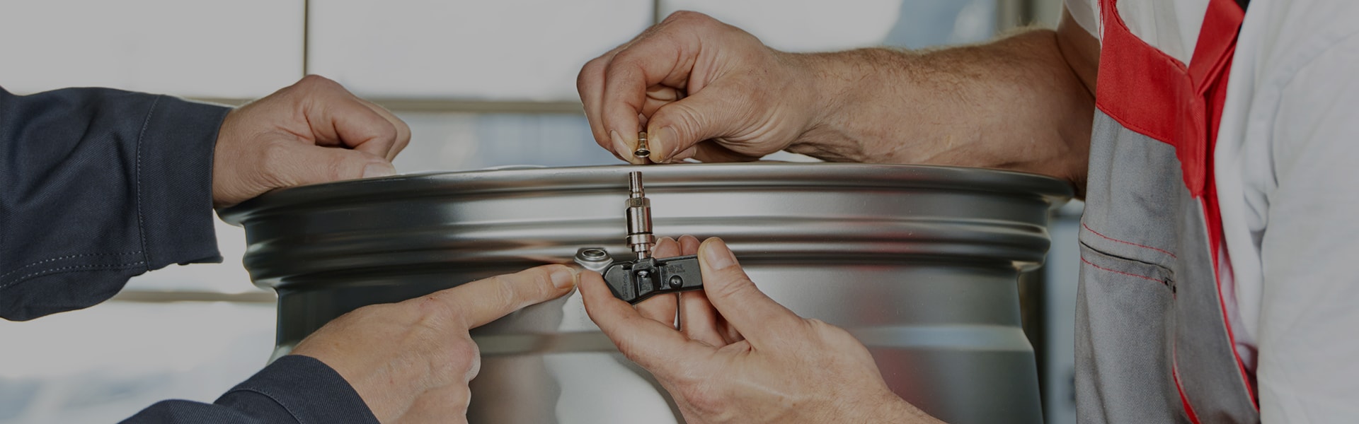 Auto Technicians Examining TPMS Sensor